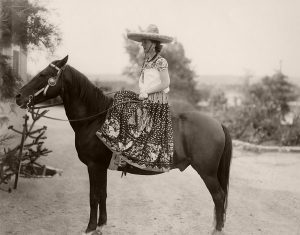 Fiesta Parade, 1932. Elizabeth White, resplendent in fiesta attire, sits astride her steed
